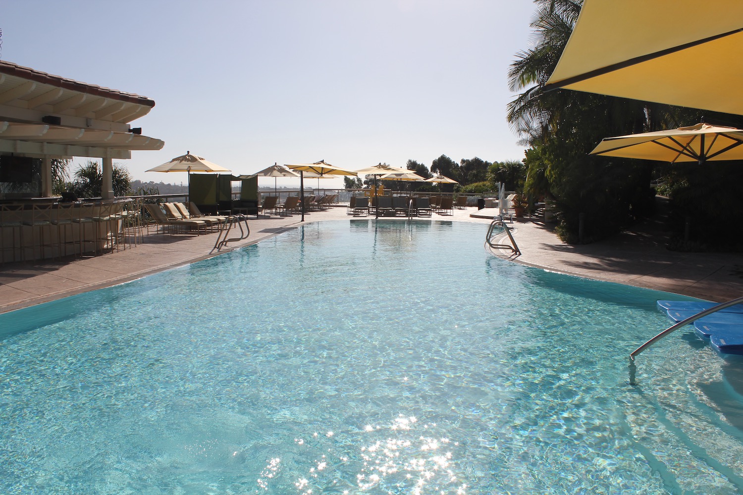 a pool with chairs and umbrellas