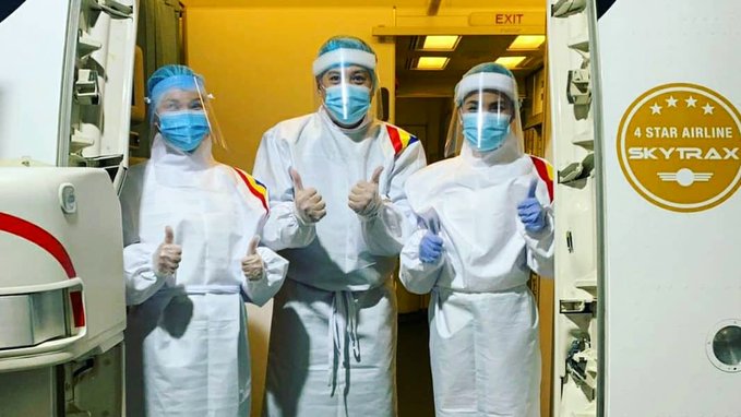 a group of people wearing face masks and gloves