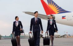 a group of people walking with luggage