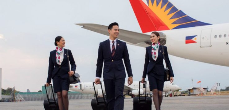 a group of people walking with luggage