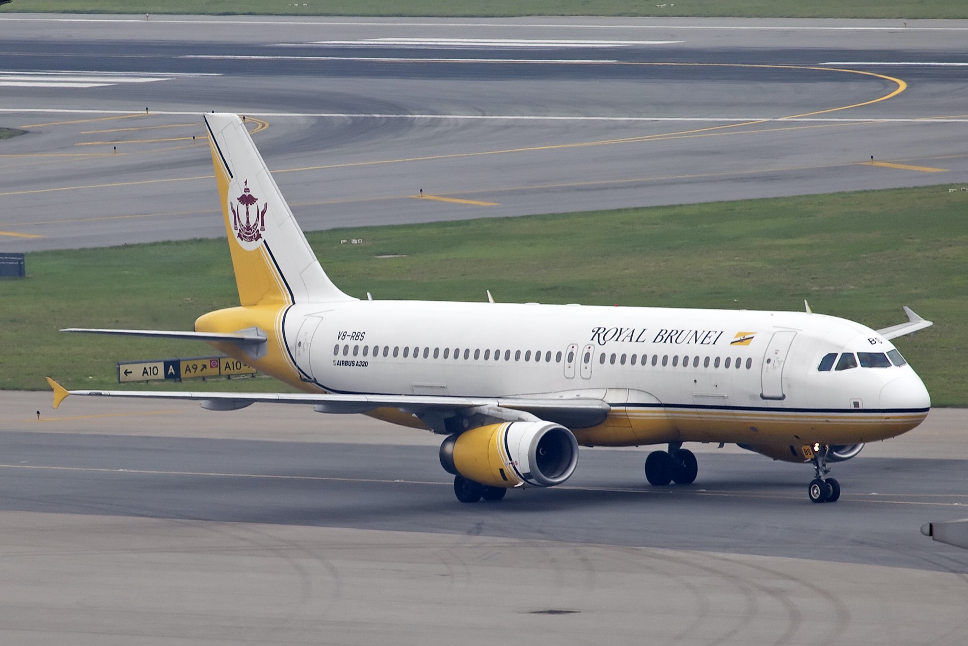 a white and yellow airplane on a runway