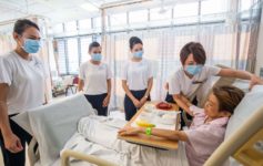 a group of people in a hospital room