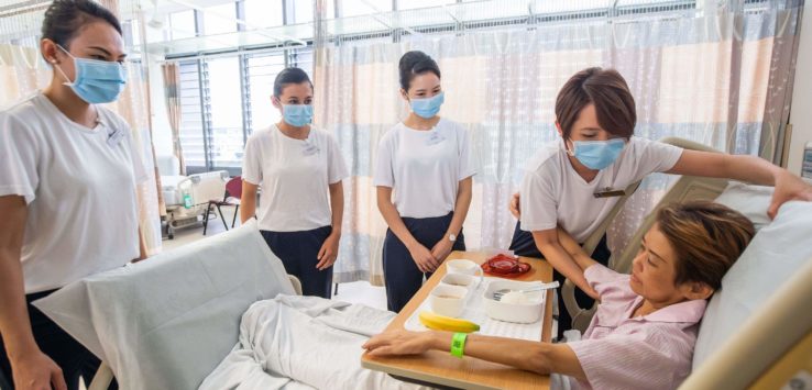 a group of people in a hospital room