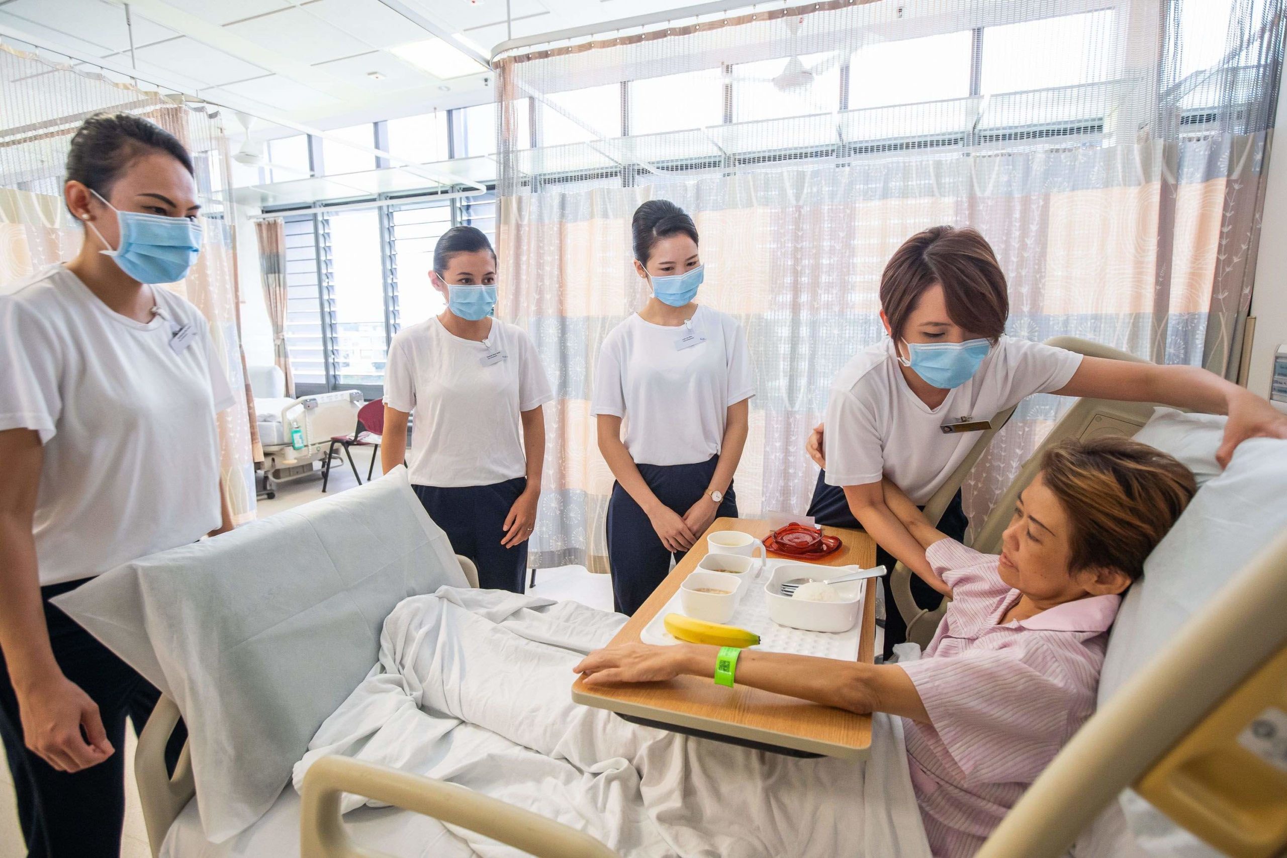 a group of people in a hospital room