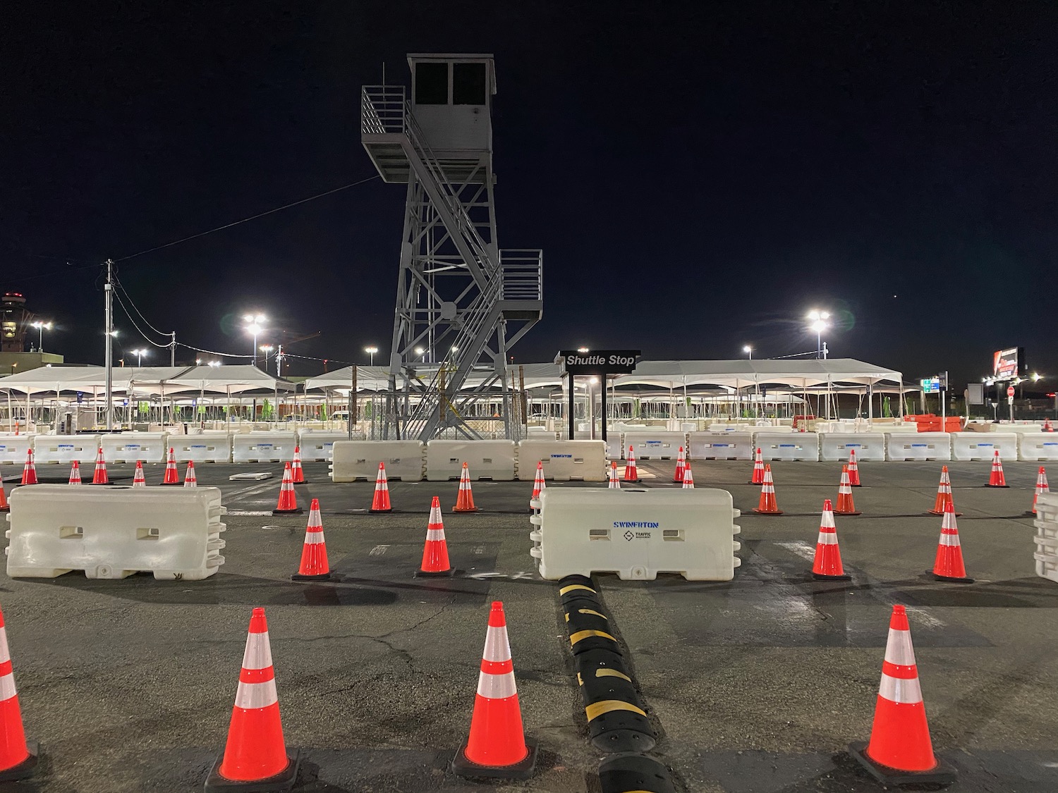 a road with orange cones and a tower