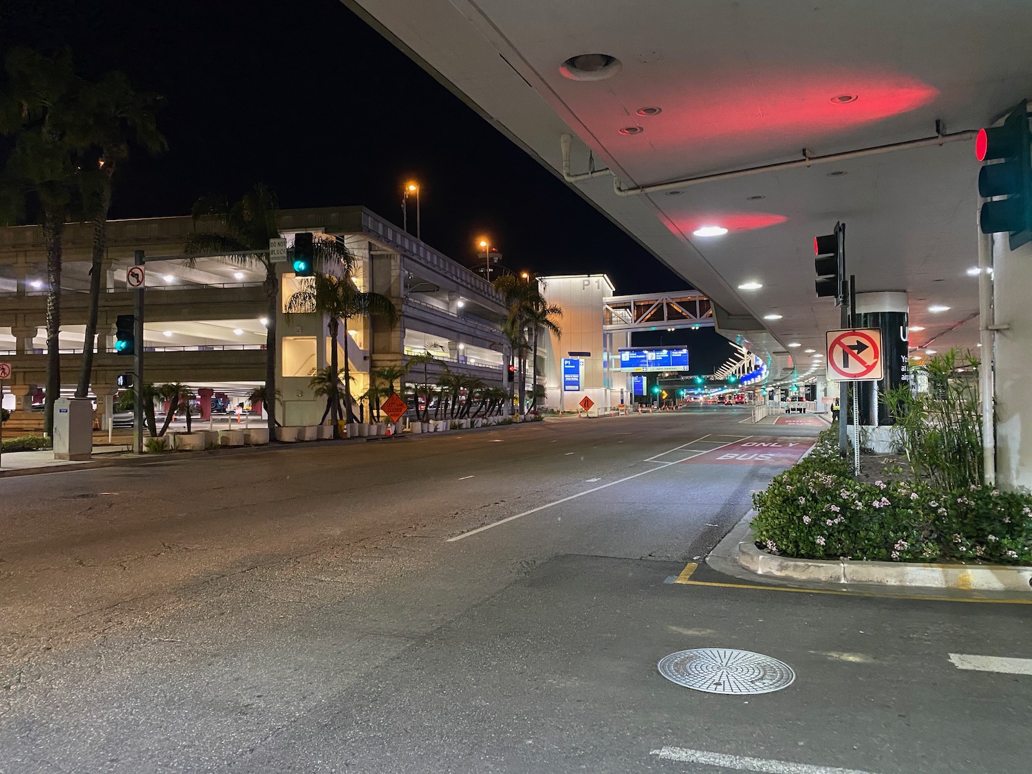 a street with a parking lot and a building