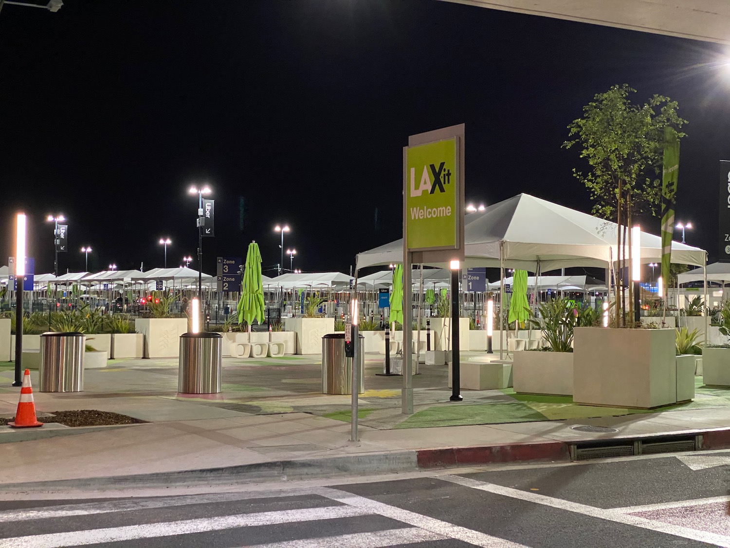 a large area with white tents and umbrellas