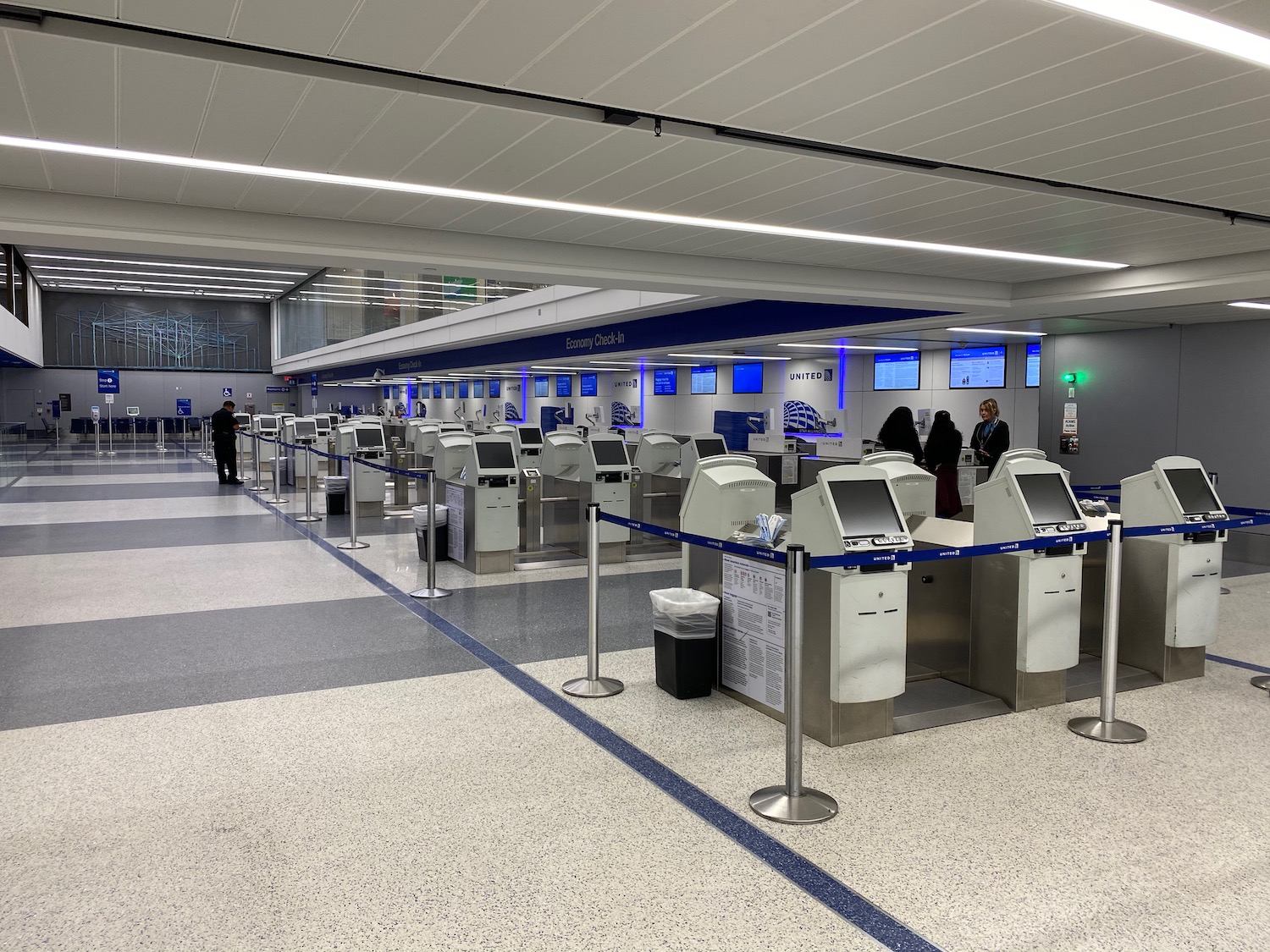 people standing in a line at an airport