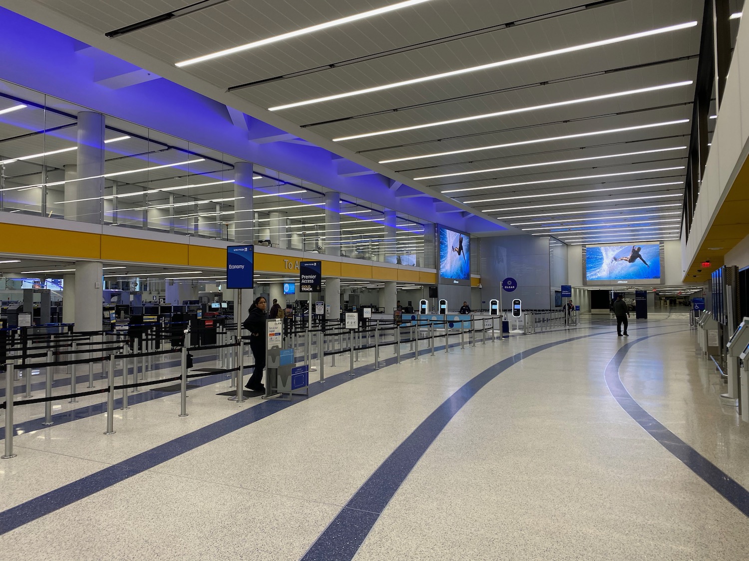 a large airport terminal with people walking around