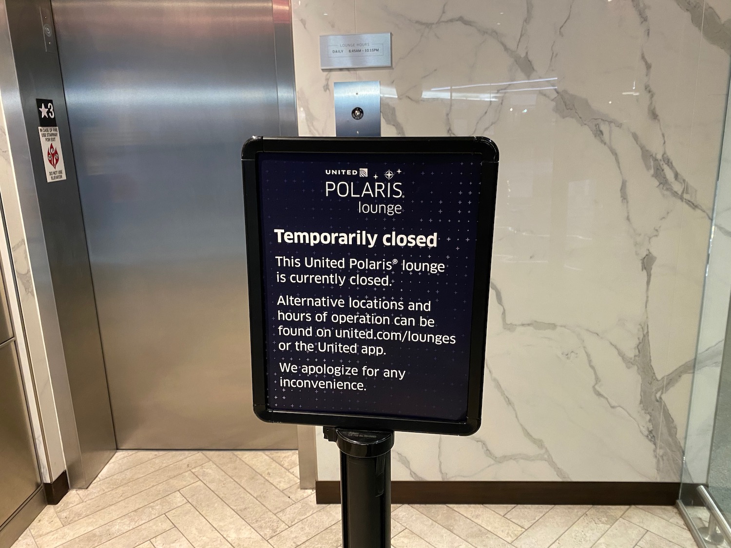 a sign in front of an elevator