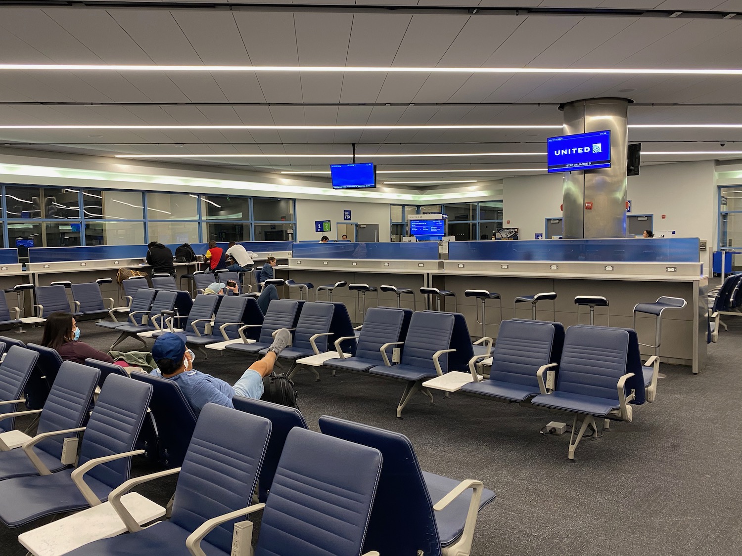 a group of people sitting in chairs in an airport