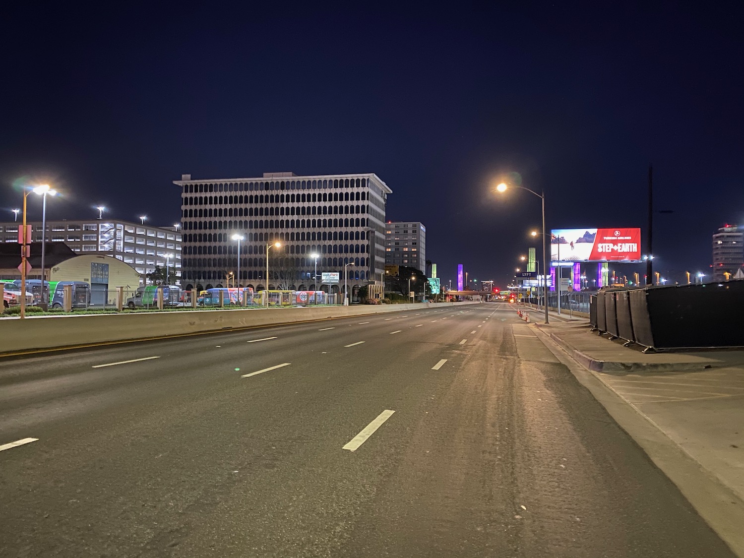 a road with buildings in the background