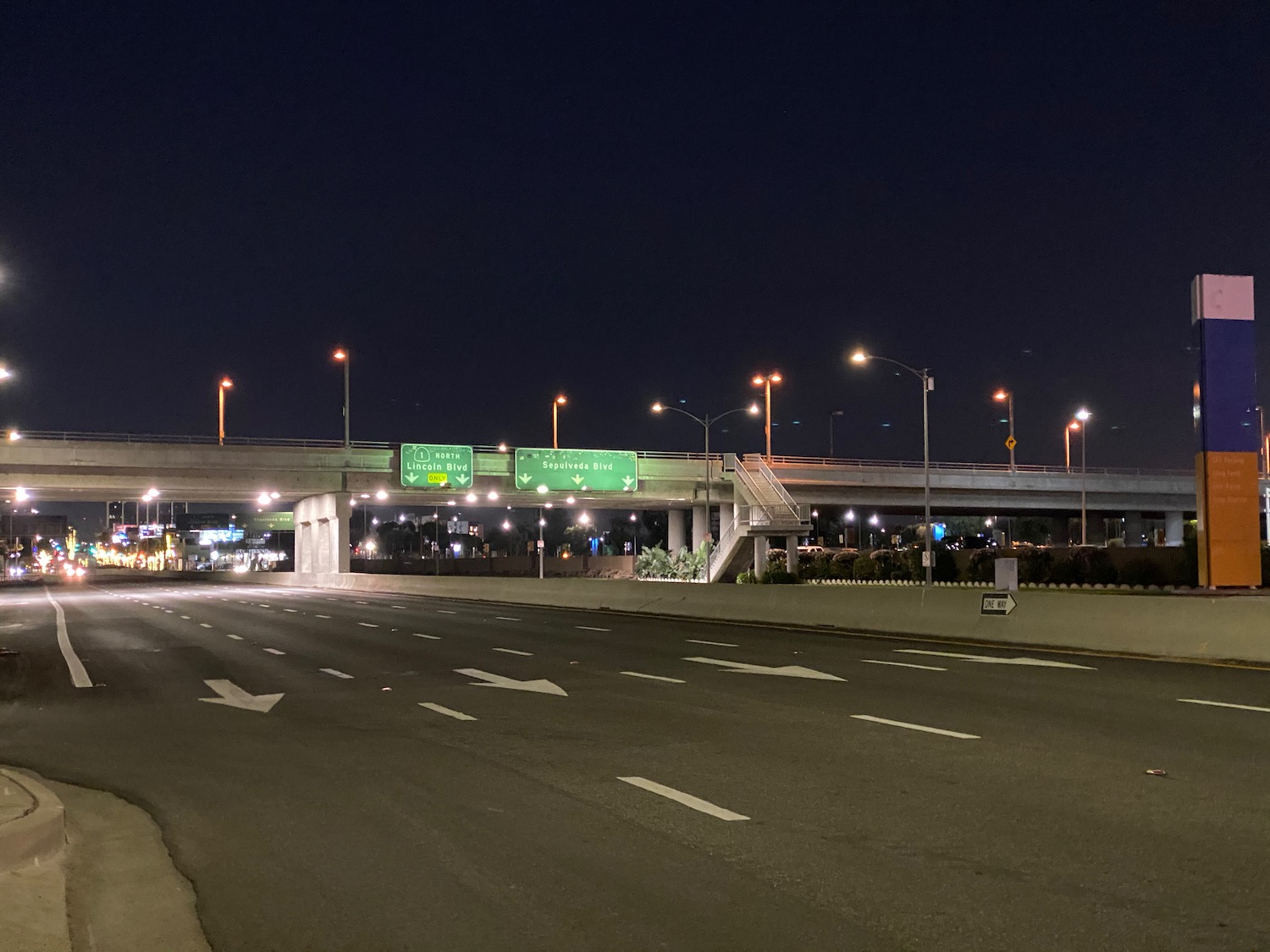 a freeway at night with a bridge over it