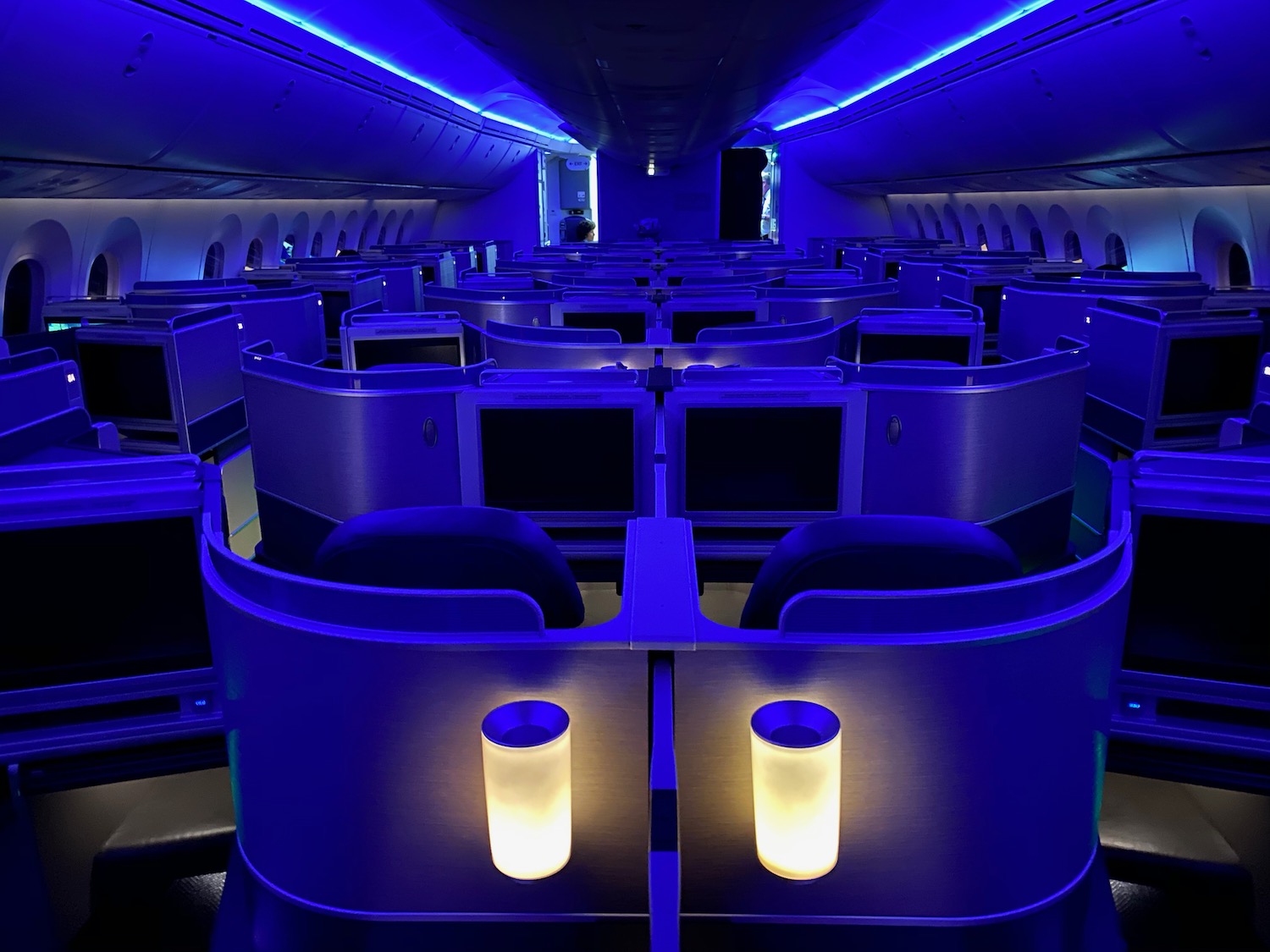 an airplane with rows of seats and a blue light