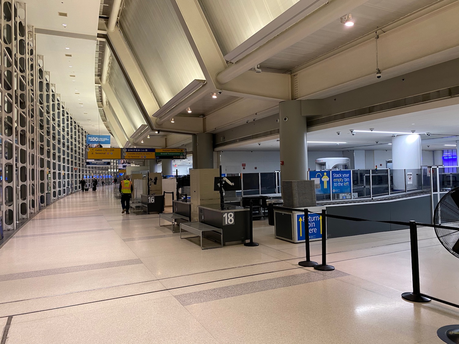 a large airport terminal with people walking