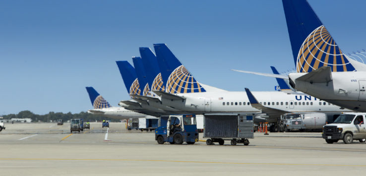 a group of airplanes parked on a runway