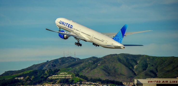 a plane flying over a runway