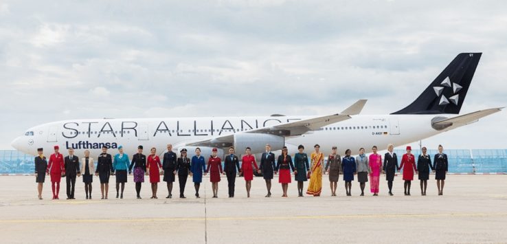 a group of people standing in front of an airplane