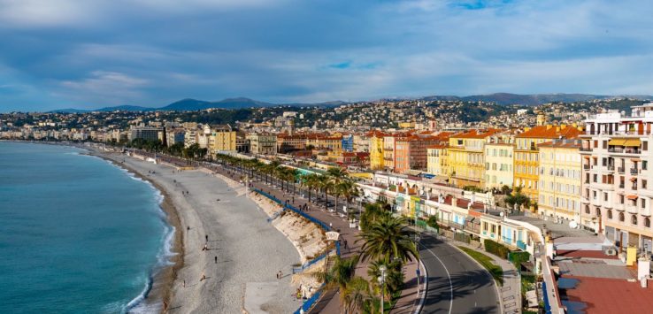 a beach with buildings and a body of water