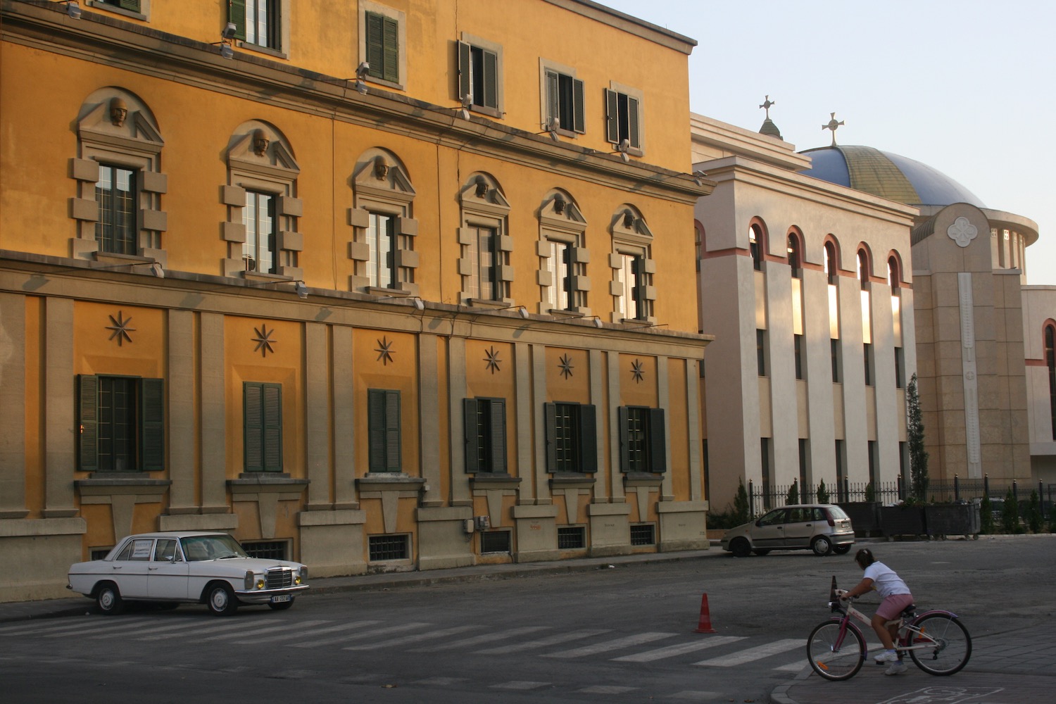 a woman riding a bicycle in front of a building