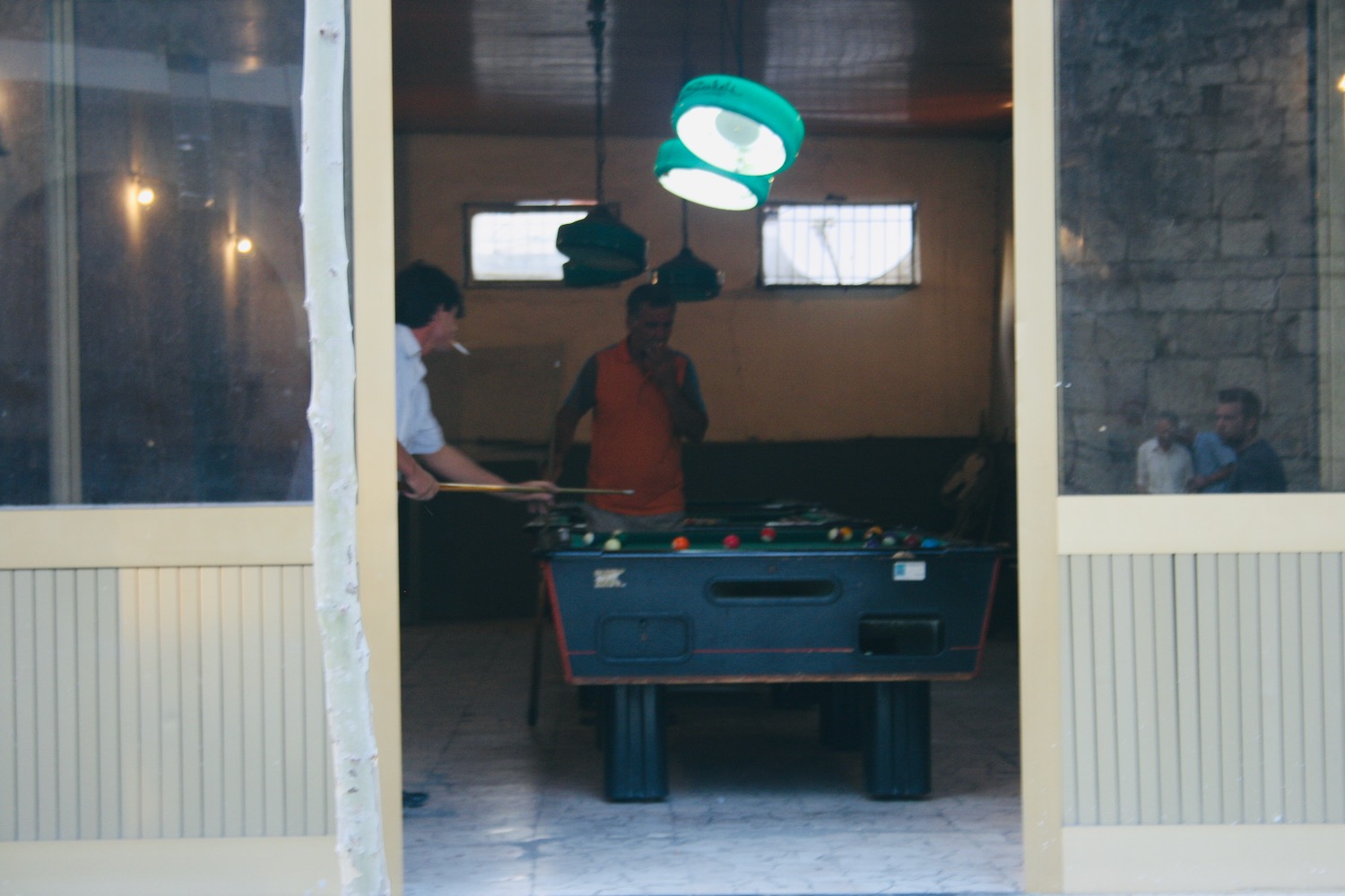 a group of men playing pool