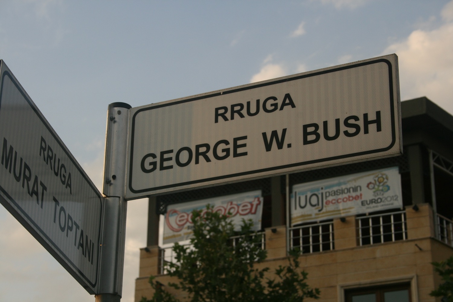a street sign with a building in the background