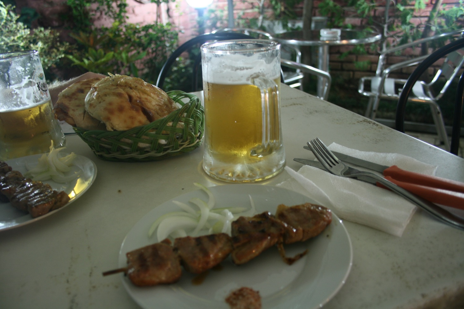 a plate of food and a glass of beer on a table