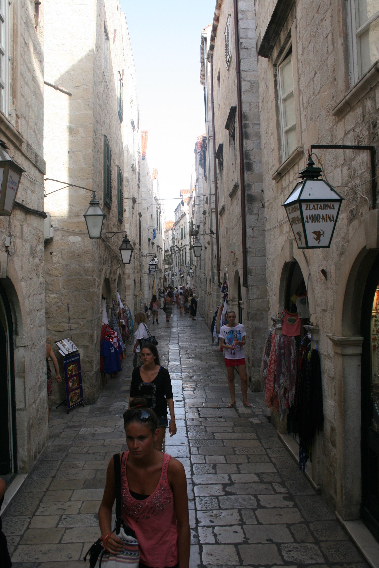 people walking through a narrow alley
