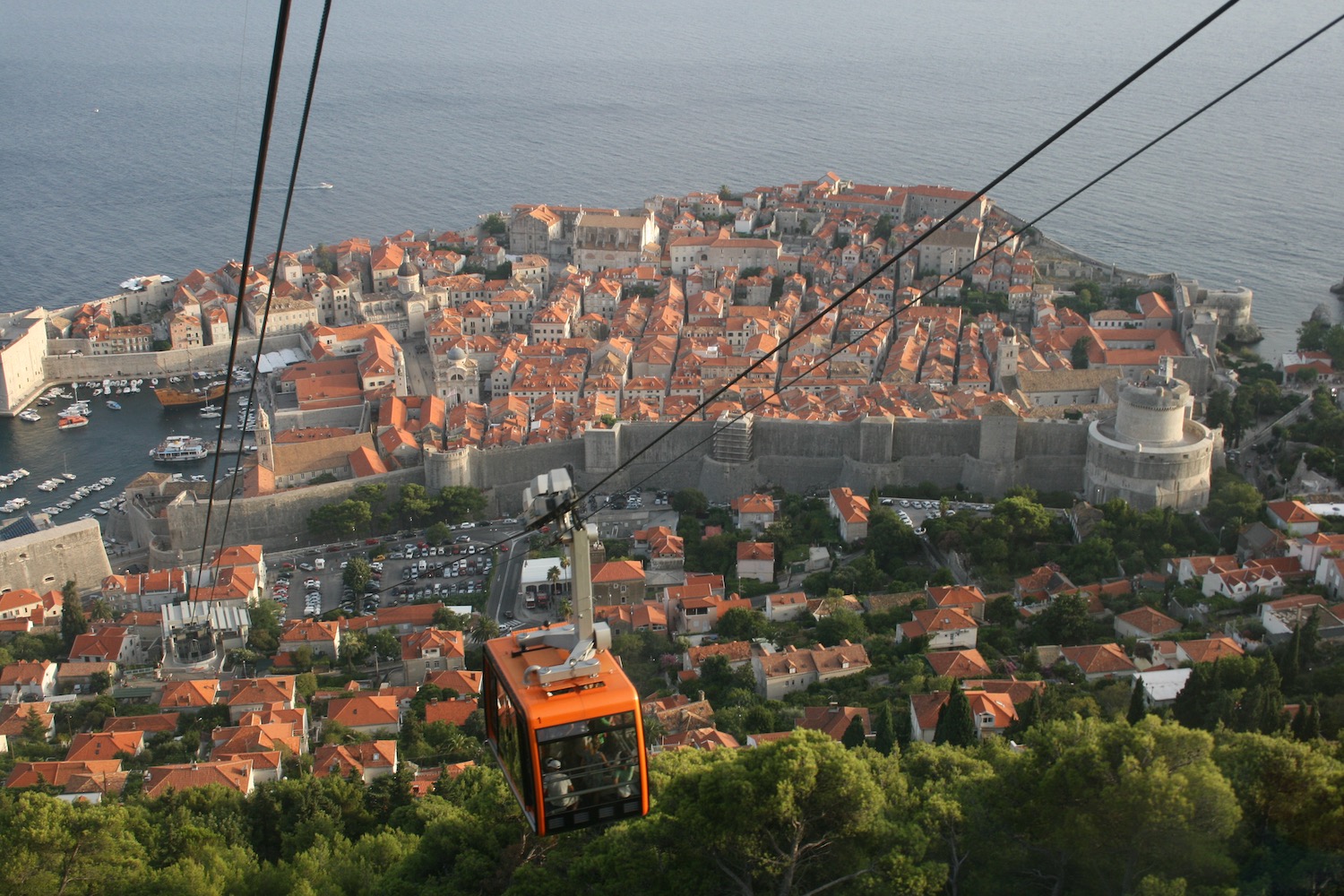 a cable car with a city in the background