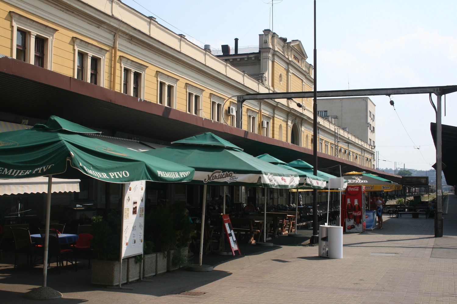 a street with umbrellas and tables