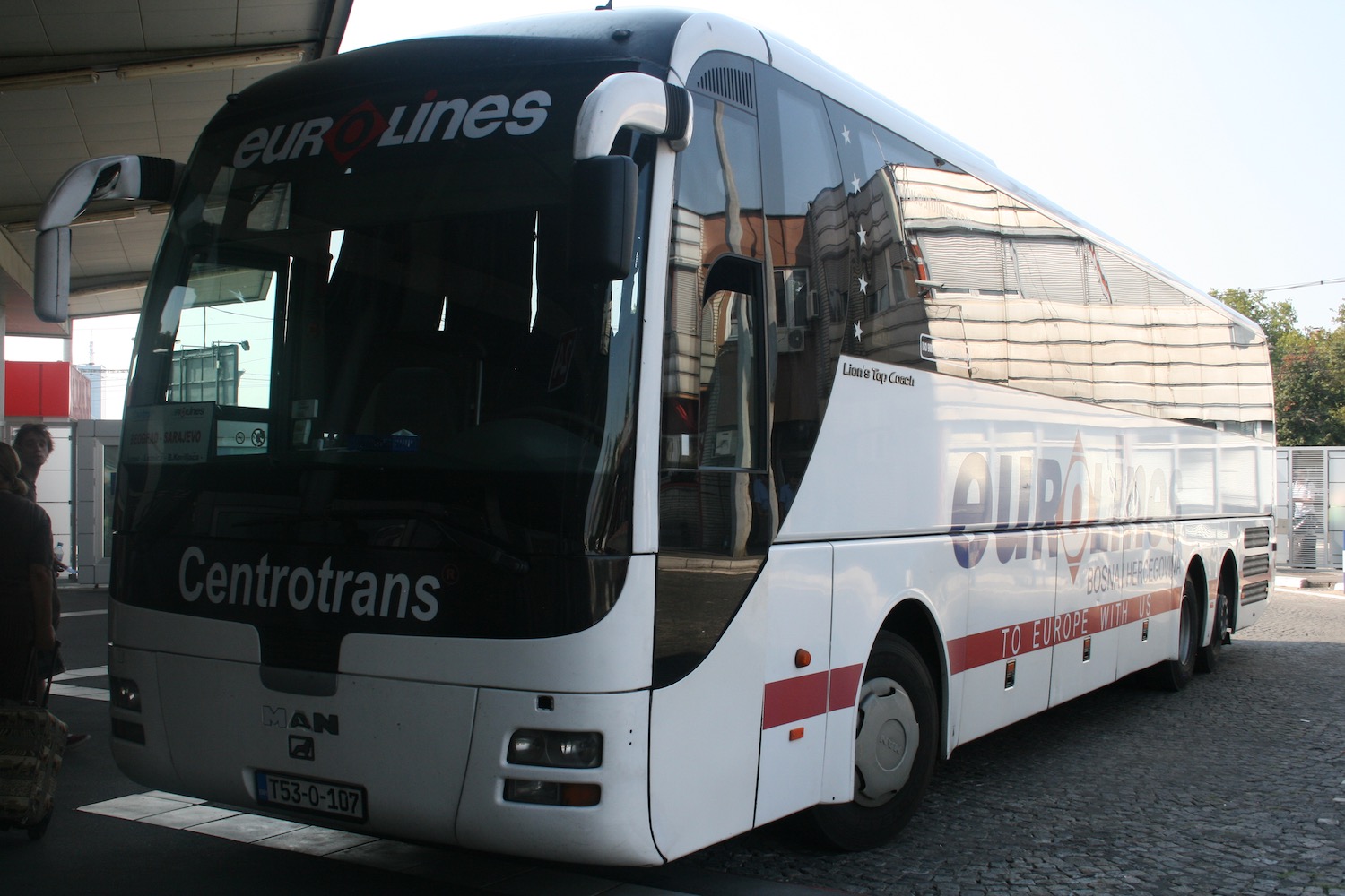 a white bus parked on a street