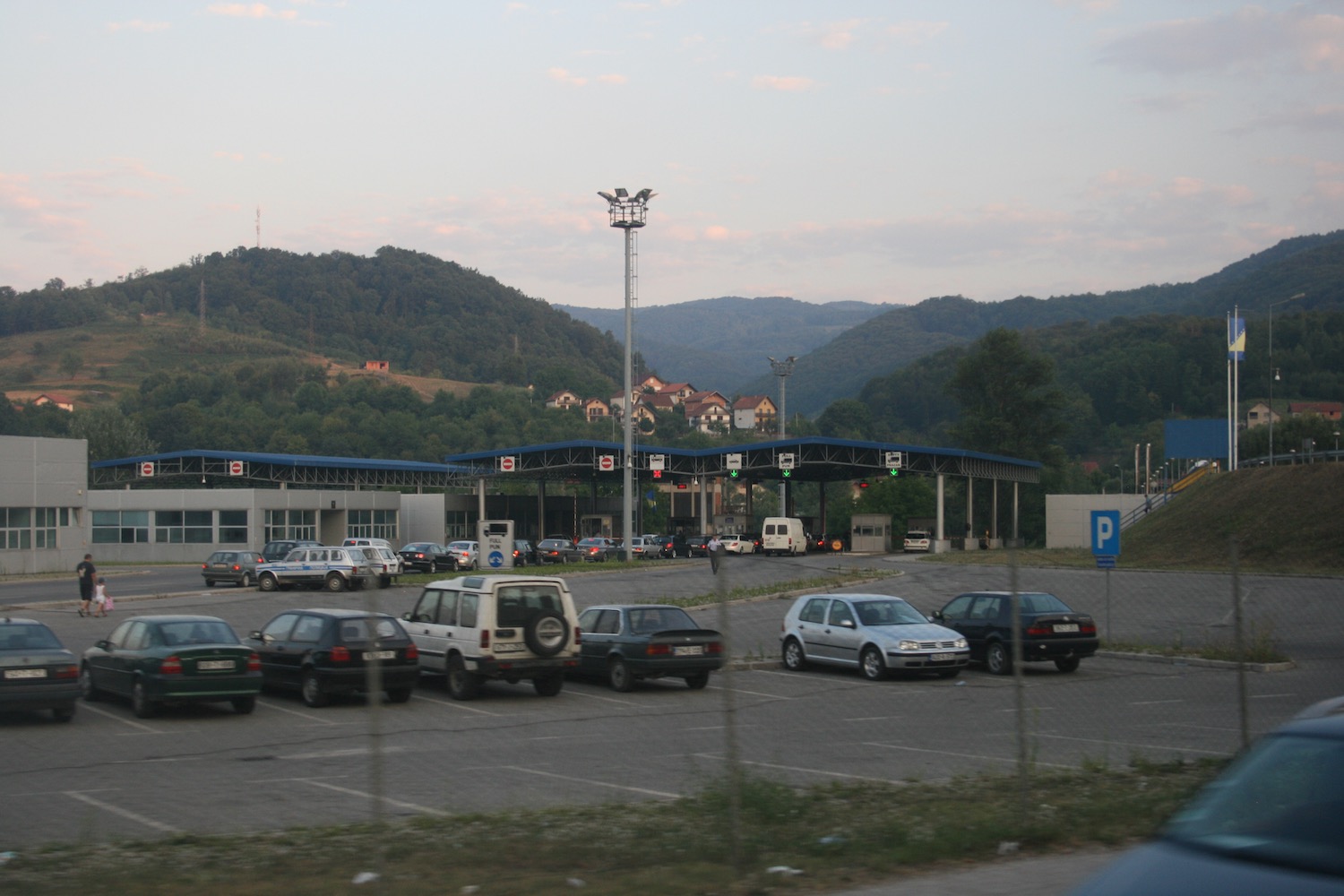 a parking lot with cars parked in front of a building