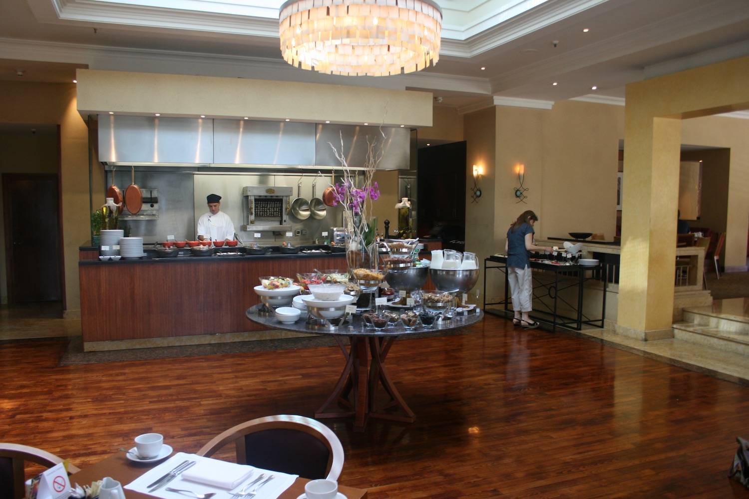 a restaurant with a large table with food on it