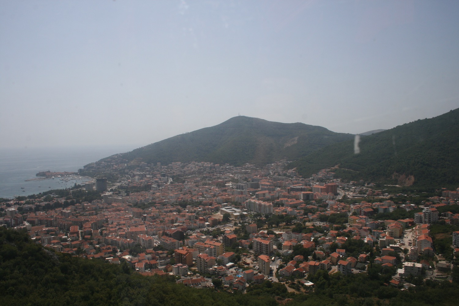 a city with many buildings and a mountain in the background