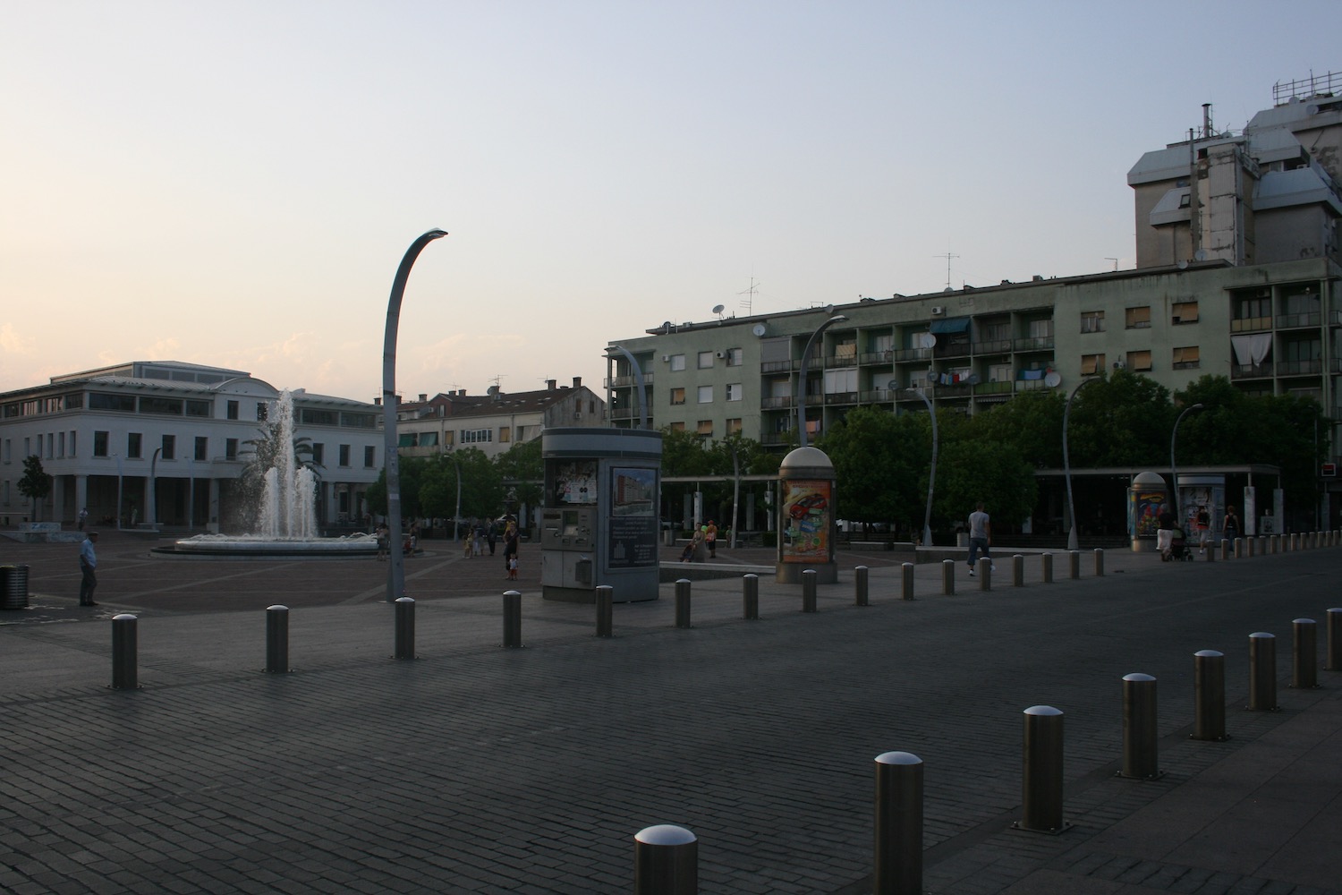 a street with buildings and a fountain