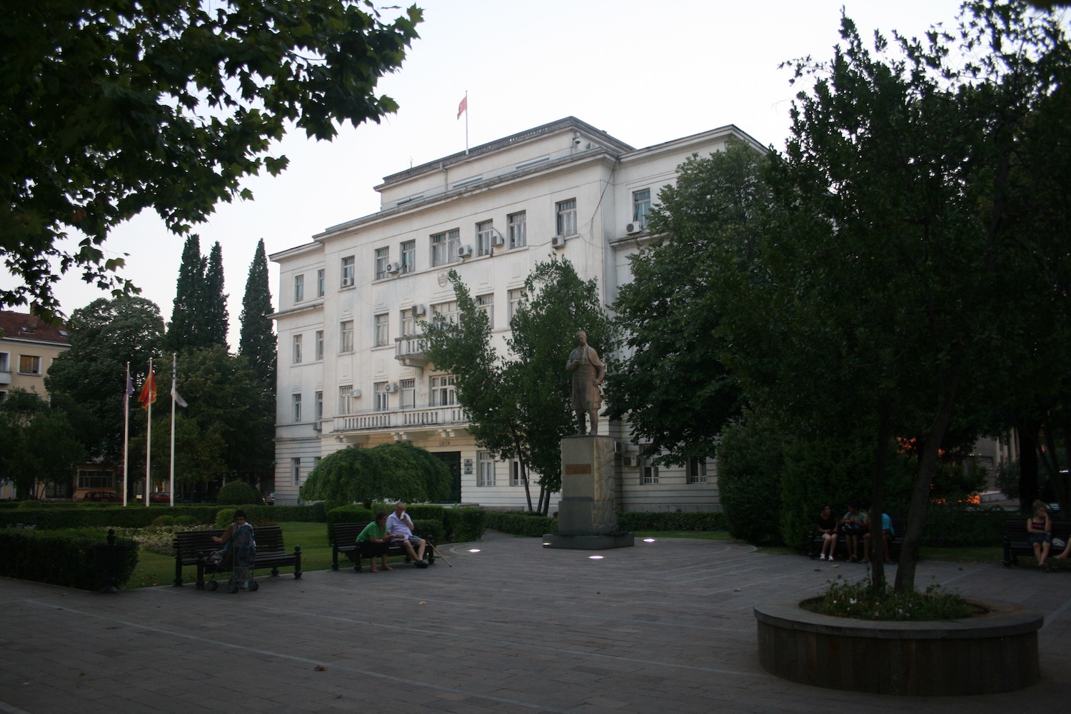 a white building with a statue in front of it