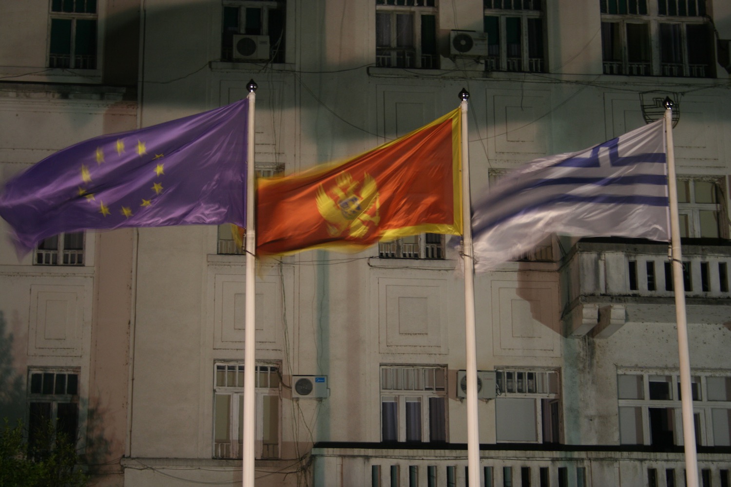 a group of flags on poles