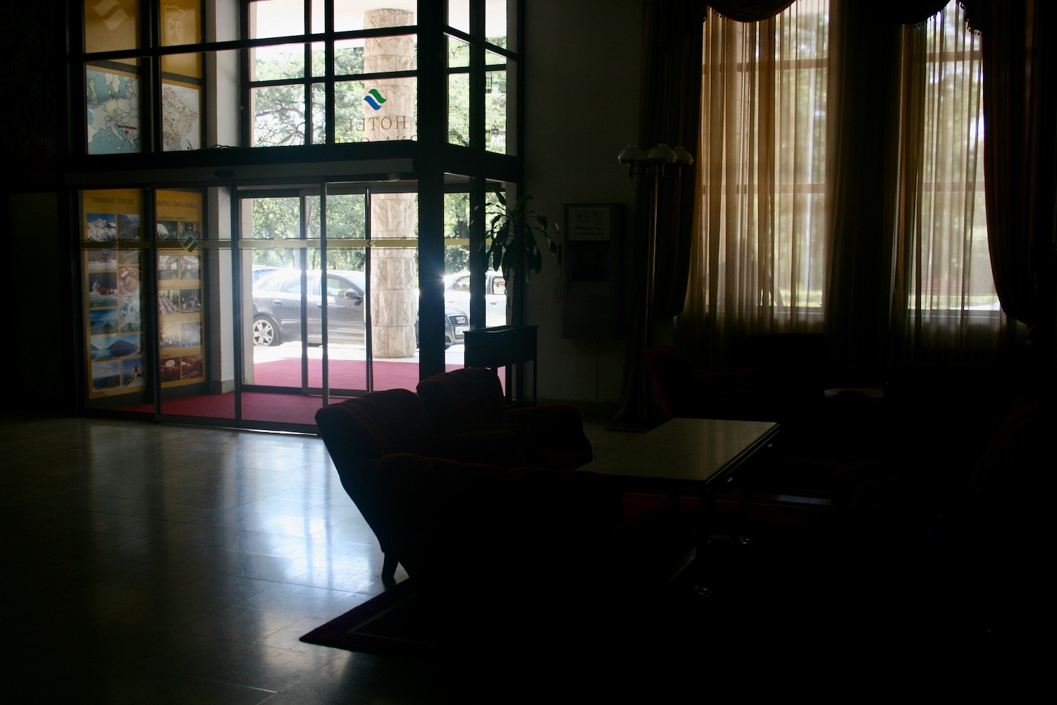 a room with a glass wall and a table and chairs