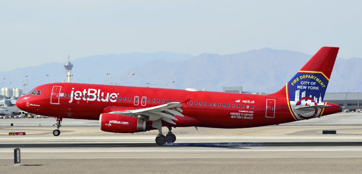 a red airplane on a runway