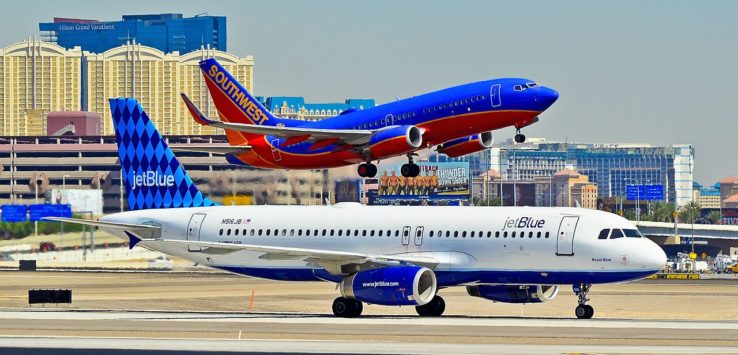 a group of airplanes on a runway