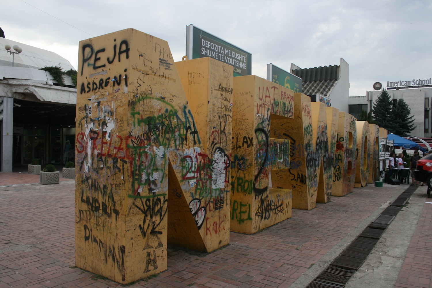 a large yellow letters with graffiti on it