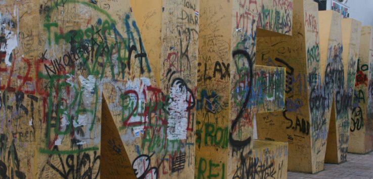 a large wooden letters with graffiti on them