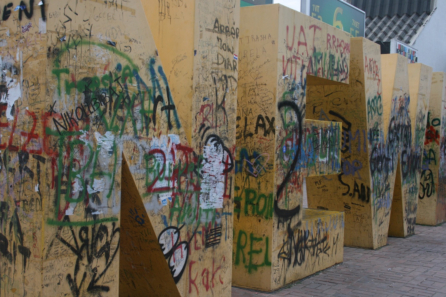 a large wooden letters with graffiti on them