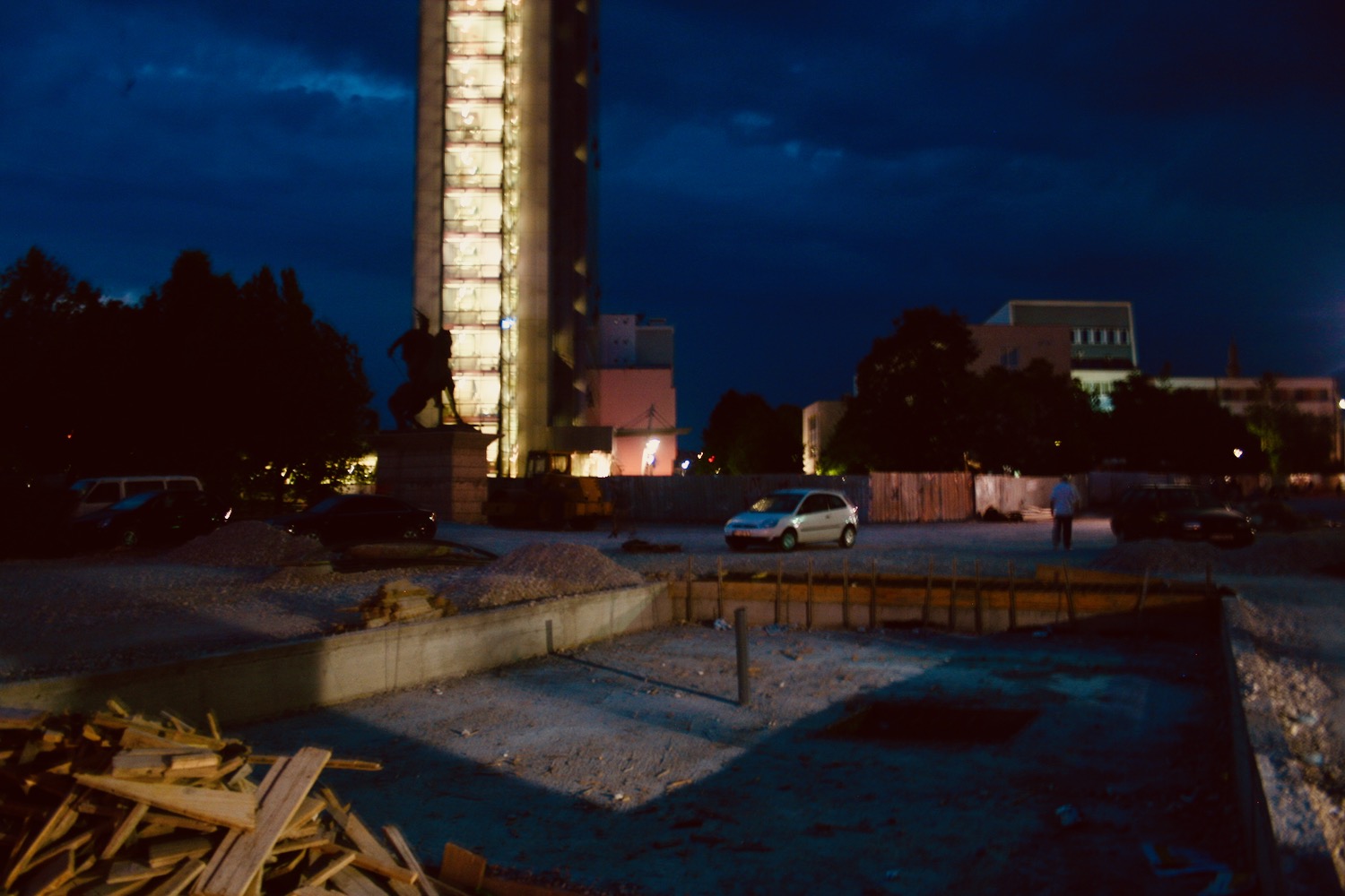 a building with a tall tower and a statue