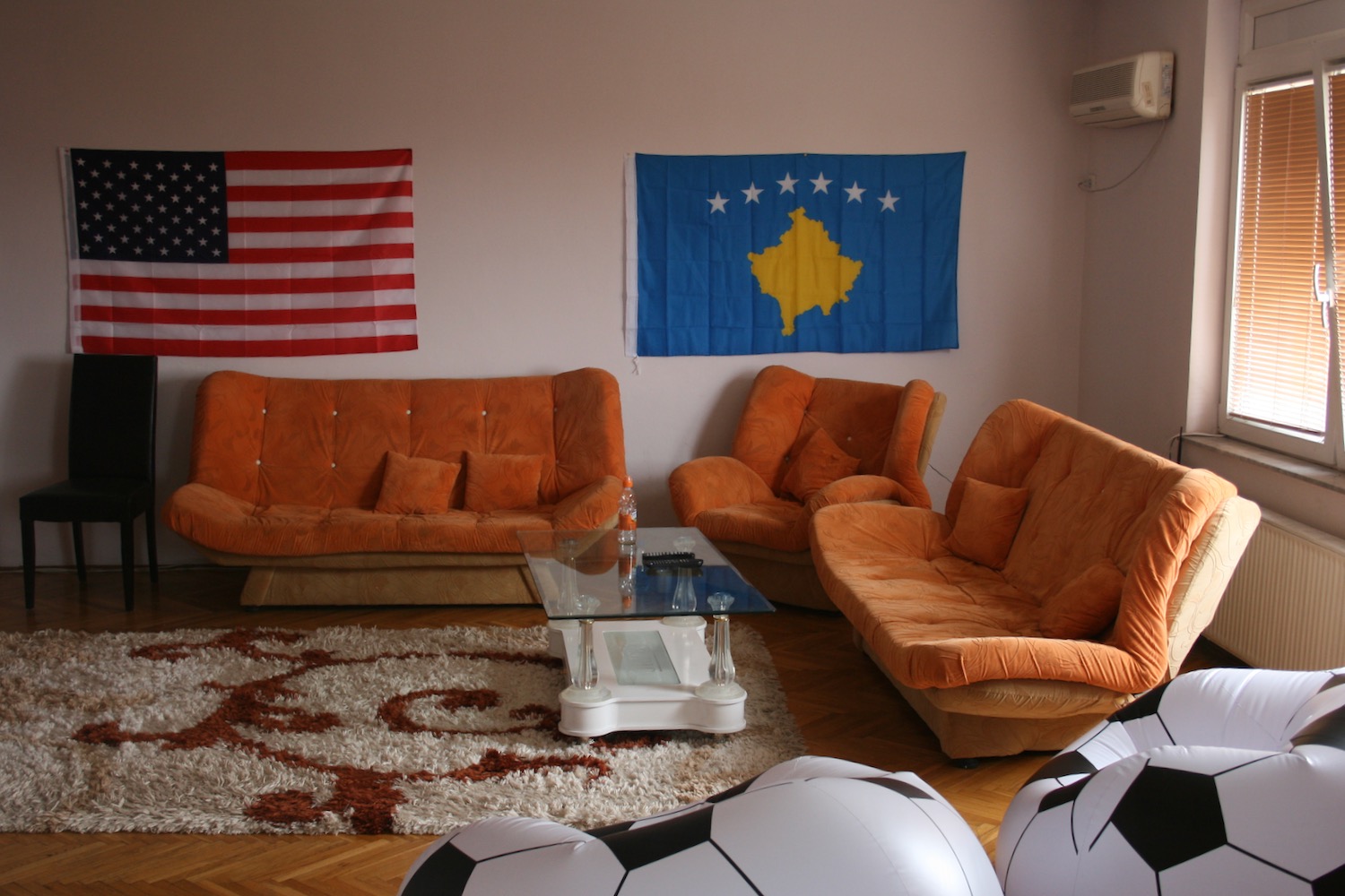 a living room with football balls and couches