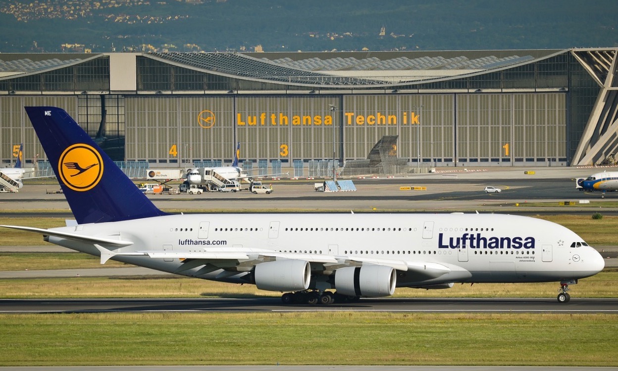 a white airplane on a runway