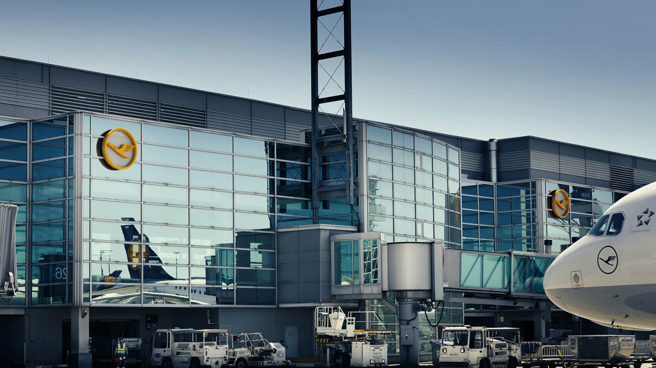 a building with windows and a plane in the background