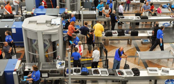 people at the airport with luggage