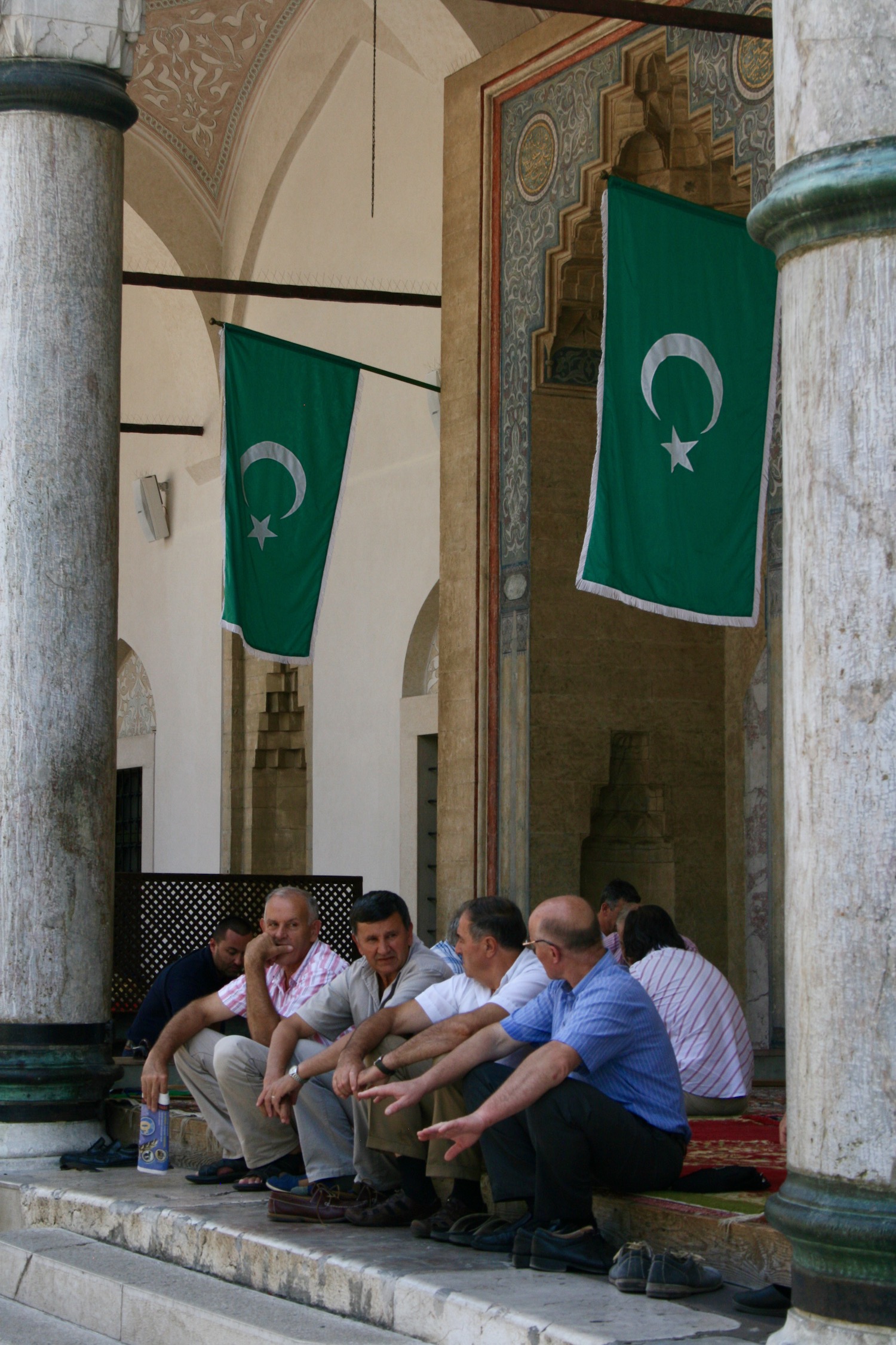 a group of men sitting on a porch