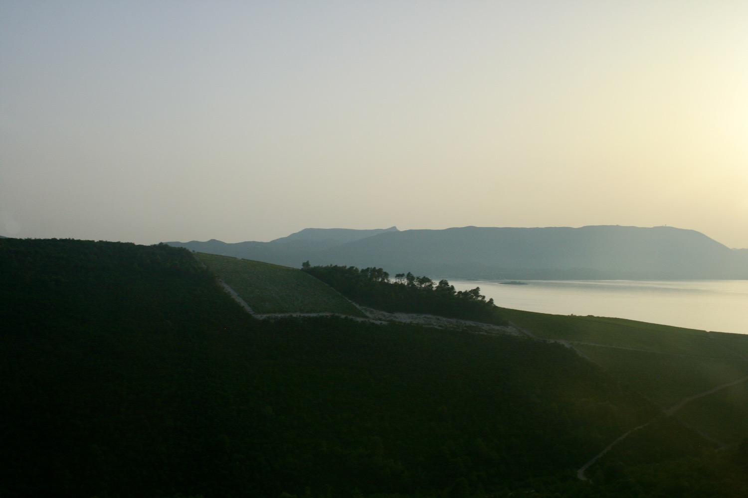 a landscape with a body of water and hills